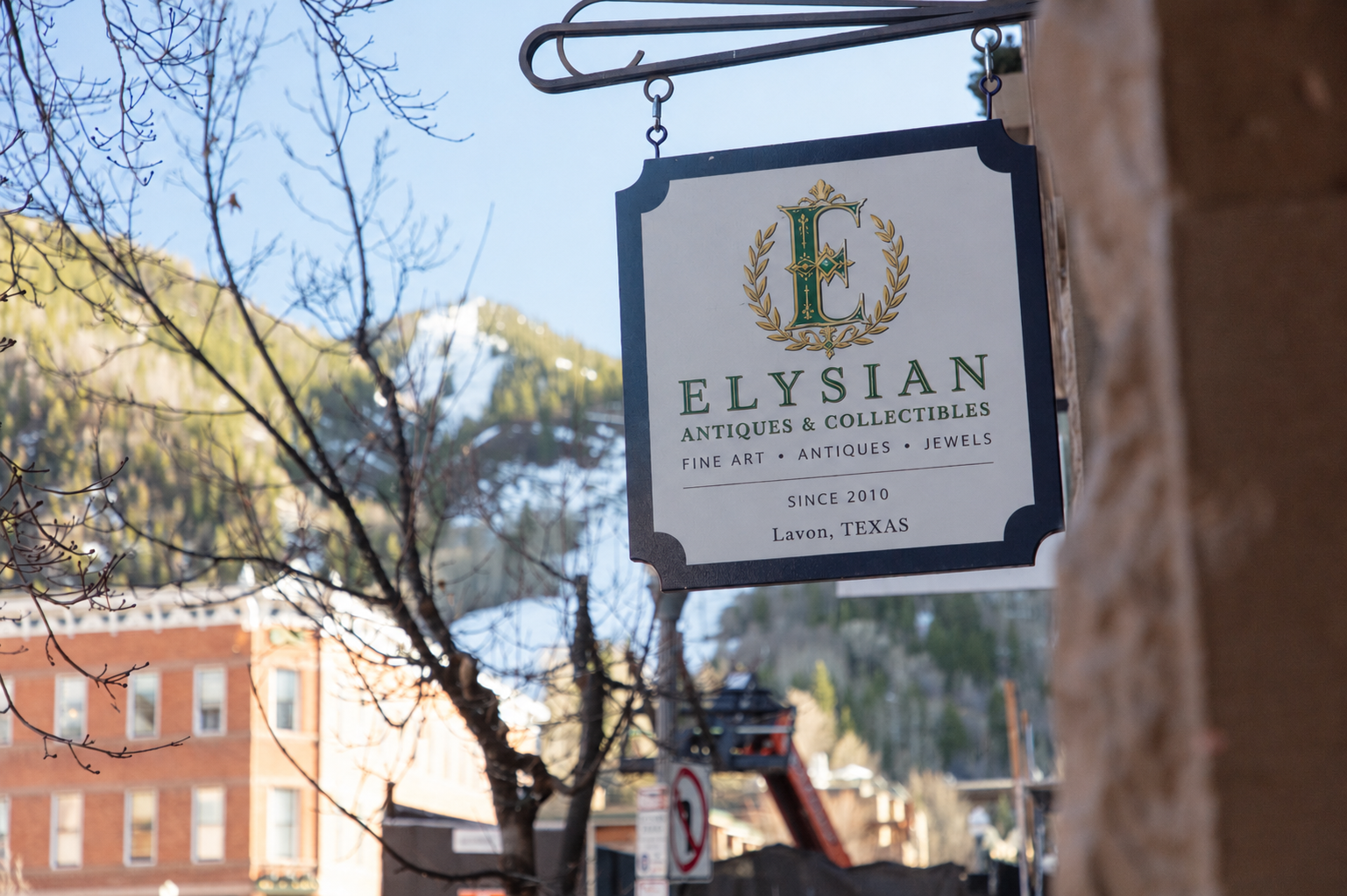 Elysian Antiques & Collectibles storefront sign in Lavon, Texas